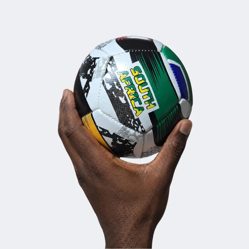SA Flag Mini Soccer Ball 12 Panel being held in hand showing mini size and design